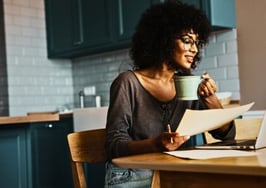 person scrolling on laptop to view home listings