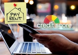 Person checking a credit history graphic on a computer next to a sticky note reading "pay rent," illustrating a factor in mortgage denials
