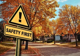 A neighborhood of houses with a safety first sign showing the importance of real estate agent safety training.