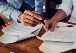 Real estate agent reviewing title documents with a homeowner client
