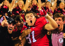 An image of college football players to represent real estate NIL moment.