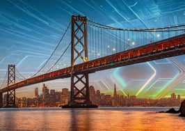 San Francisco housing market skyline behind Bay Bridge with digital tech overlay