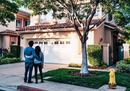 An image of a couple looking at a house to represent why homeowners aren’t selling