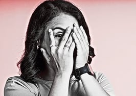 A woman with her hands over her face, peeking through the fingers to represent cringeworthy home staging practices