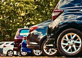 Cars parked in a parking lot to represent the author's analogy of buyers waiting for rates are like drivers looking for a closer parking spot and the mortgage rate scripts agents need today.