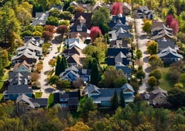 Houses on a forested western North Carolina mountainside as a Native American housing bill awaits Senate action