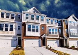A row of single-family houses in a U.S. suburb, illustrating the income to buy a home.