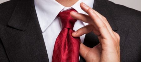 A man adjusting his necktie