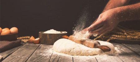 A man kneading bread dough