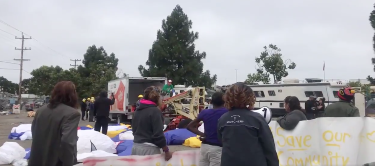 Developer fans cash at homeless encampment in ploy to clear site