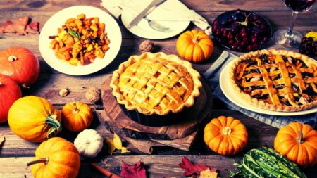 A picture of a Thanksgiving table replete with pies to represent fall-themed stop-by ideas.
