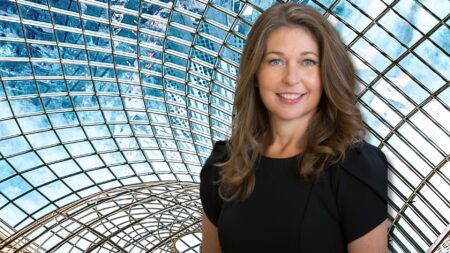 A woman in leadership standing in front of a glass cliff, which represents the struggles women in leadership face today.
