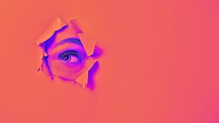 Woman's eye showing through tear in paper to symbolize Opendoor's CEO resignation.