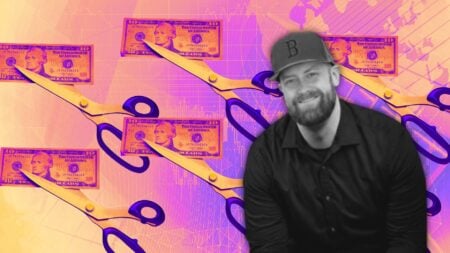 A picture of scissors cutting through a ten-dollar bill to symbolize cutting your real estate marketing spend.