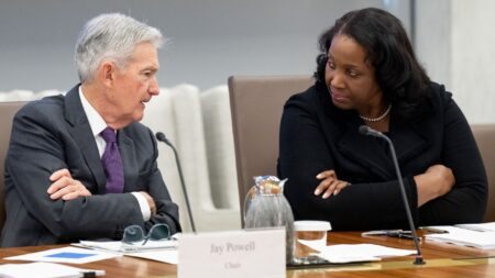 Federal Reserve Governor Lisa Cook speaks with Fed Chair Jerome Powell at a June 25, 2025 open meeting at the Federal Reserve Board building in Washington, D.C.