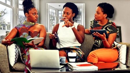 3 African-American single women homebuyers talking with each other on the couch.