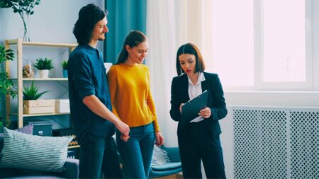 An agent showing a home to clients to represent how to survive your first year in real estate.