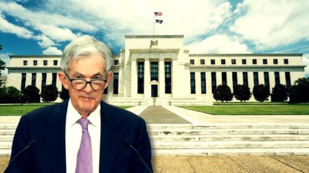 Fed Chair Jerome Powell standing in front of the Federal Reserve building to illustrate how the federal reserve impacts real estate.