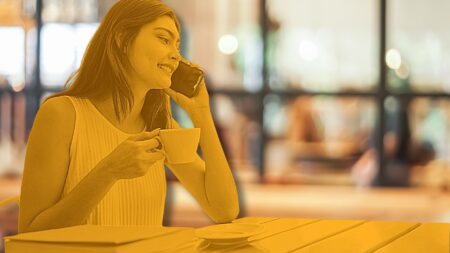 A real estate agent on the phone in her office following up after a client meeting to represent Why Most Real Estate Agents Lose The Deal.