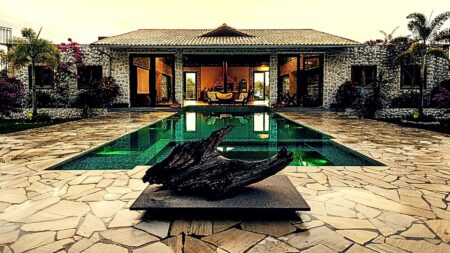 A mansion with a pool and sculpture to exemplify bespoke real estate marketing.