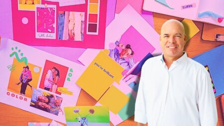 A picture of contributor Jimmy Burgess in front of a board of marketing to symbolize effective real estate marketing campaigns.