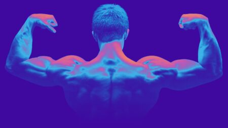 A muscular man with his back to the camera flexing his arm muscles