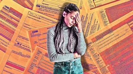 An image of a stressed woman standing in front of IRS forms to symbolize year-end tax planning tips real estate agents.
