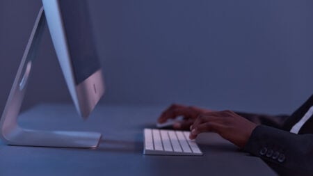 man freelancer sitting corporate happy desk work information keyboard business lifestyle online african american technology night businessman blogger african successful computer finance