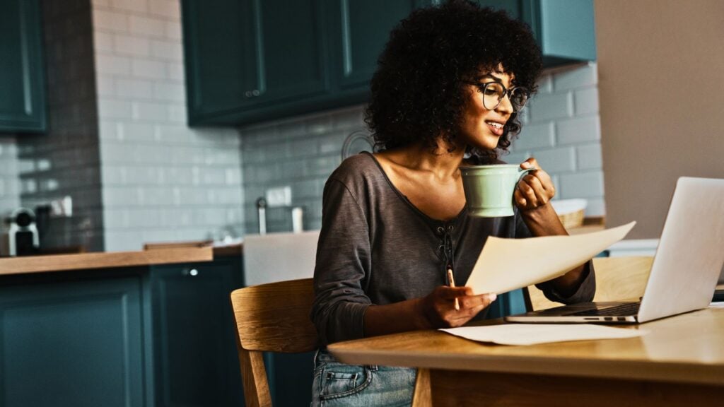 person scrolling on laptop to view home listings