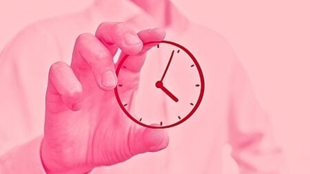 An image of a hand holding a clock to represent a full-time real estate agent.