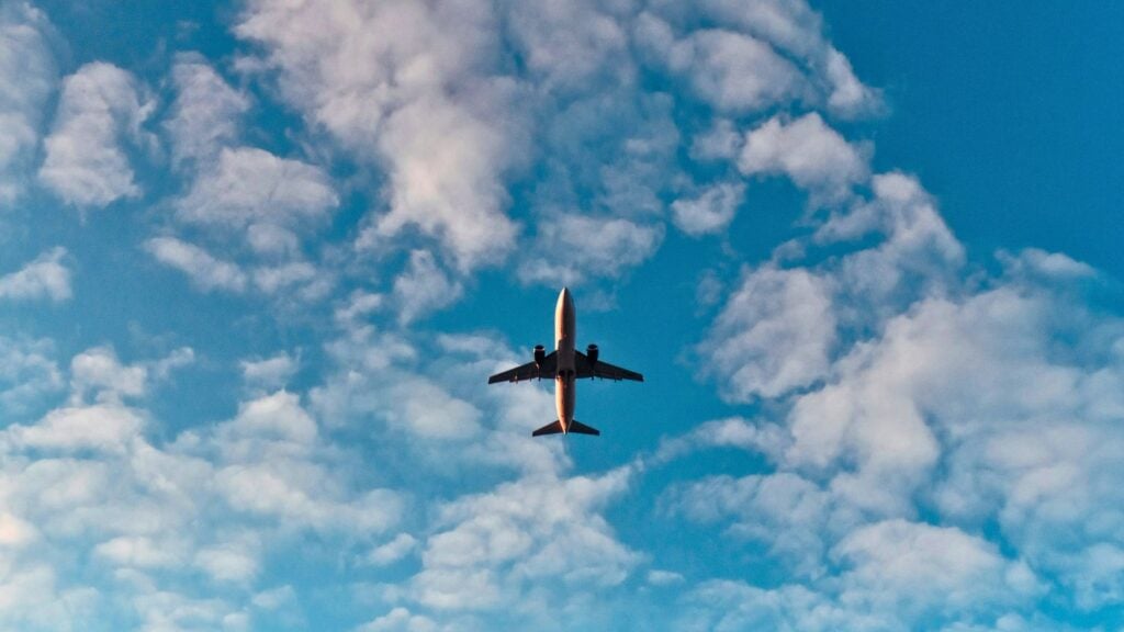 Commercial airplane in flight, illustrating story about a real estate agent restrained on a flight
