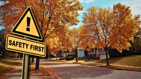 A neighborhood of houses with a safety first sign showing the importance of real estate agent safety training.