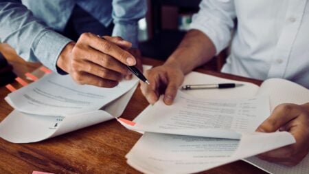Real estate agent reviewing title documents with a homeowner client