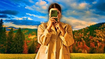 An image of a woman standing in front of an autumnal background to represent fall video content ideas.