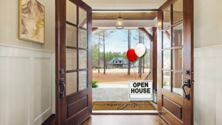 An image of a door open with open house balloons outside to represent Krys Benyamein's open house launch plan.