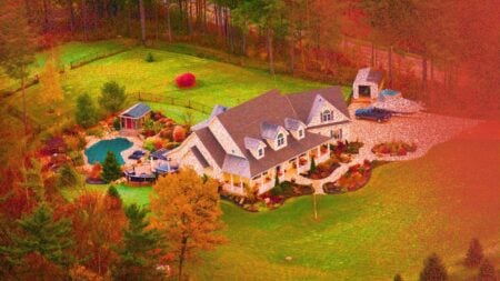 A picture of a home surrounded by fall foliage to represent 2026 luxury homebuyer trends this fall.
