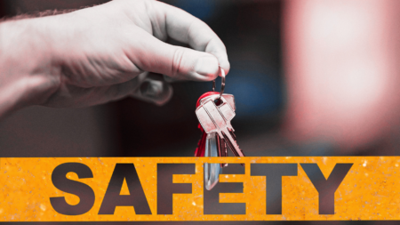 An image of keys in a hand over safety tape to signify real estate safety resources.