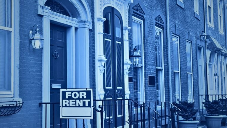 For-rent sign outside a single-family home, illustrating the cost gap in renting vs. buying