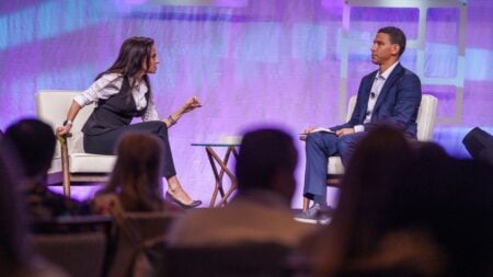 CMLS CEO Jessica Edgerton and Compass CEO Robert Reffkin on stage at the CMLS Open House conference in Fort Lauderdale, Florida, before Edgerton announced the CMLS legal action fund.