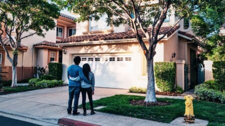 An image of a couple looking at a house to represent why homeowners aren’t selling