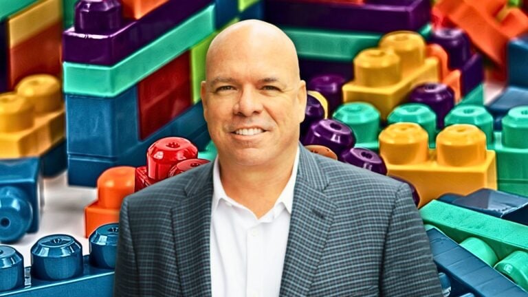 An image of Jimmy Burgess in front of legos to represent how to increase real estate income.