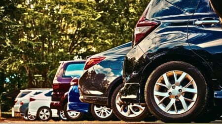 Cars parked in a parking lot to represent the author's analogy of buyers waiting for rates are like drivers looking for a closer parking spot and the mortgage rate scripts agents need today.