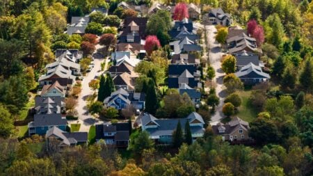 Houses on a forested western North Carolina mountainside as a Native American housing bill awaits Senate action