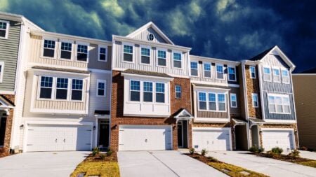 A row of single-family houses in a U.S. suburb, illustrating the income to buy a home.