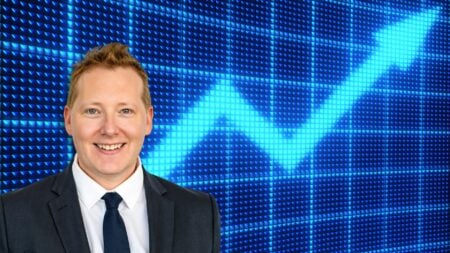 Kyle Crawford in front of an upward trending chart to signify mortgage rate objections.