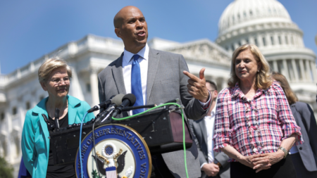 U.S. Sen Cory Booker (D-NJ) (C), joined by Sen. Elizabeth Warren (D-MA) (L) and Rep. Carolyn Maloney (D-NY) speaks at a press conference in Washington, DC. The Warren, Booker real estate letter to the FTC urges probe on commission-sharing, private listings